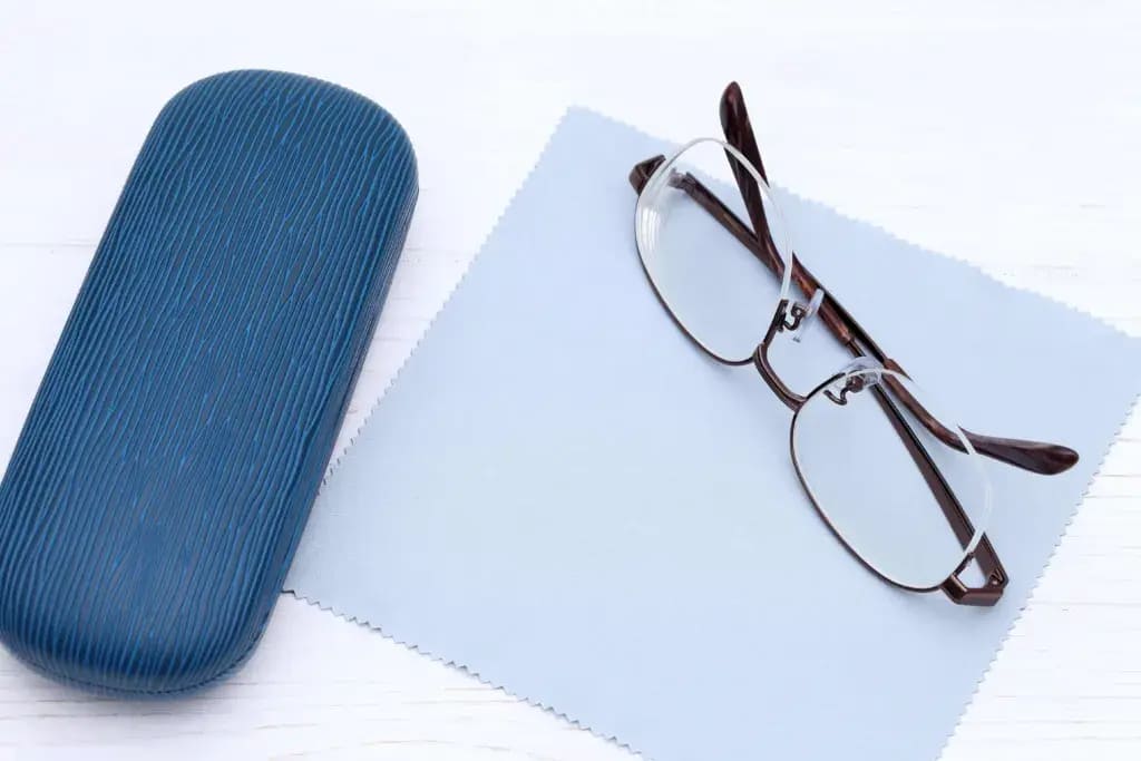 A blue glasses case alongside glasses