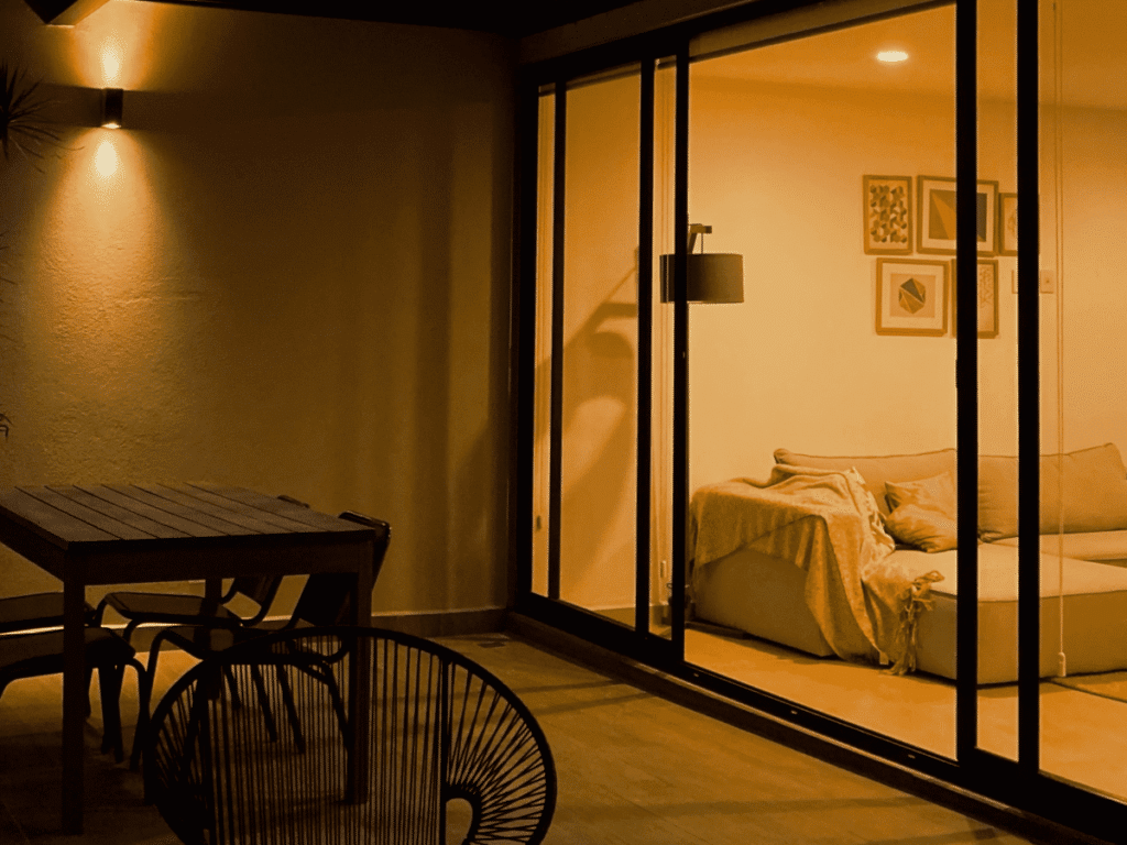 A night view of a house with a sliding glass door