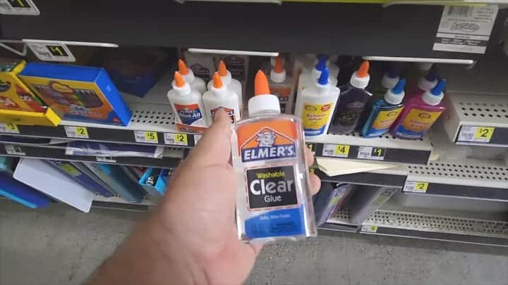 A perosn holding Elmer's glue at a shopping store