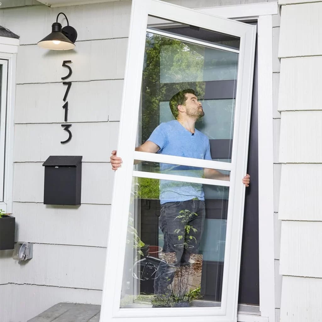 A person holding the opening of sliding glass door