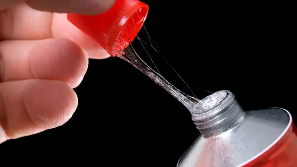 A person removing a sticky glue cap