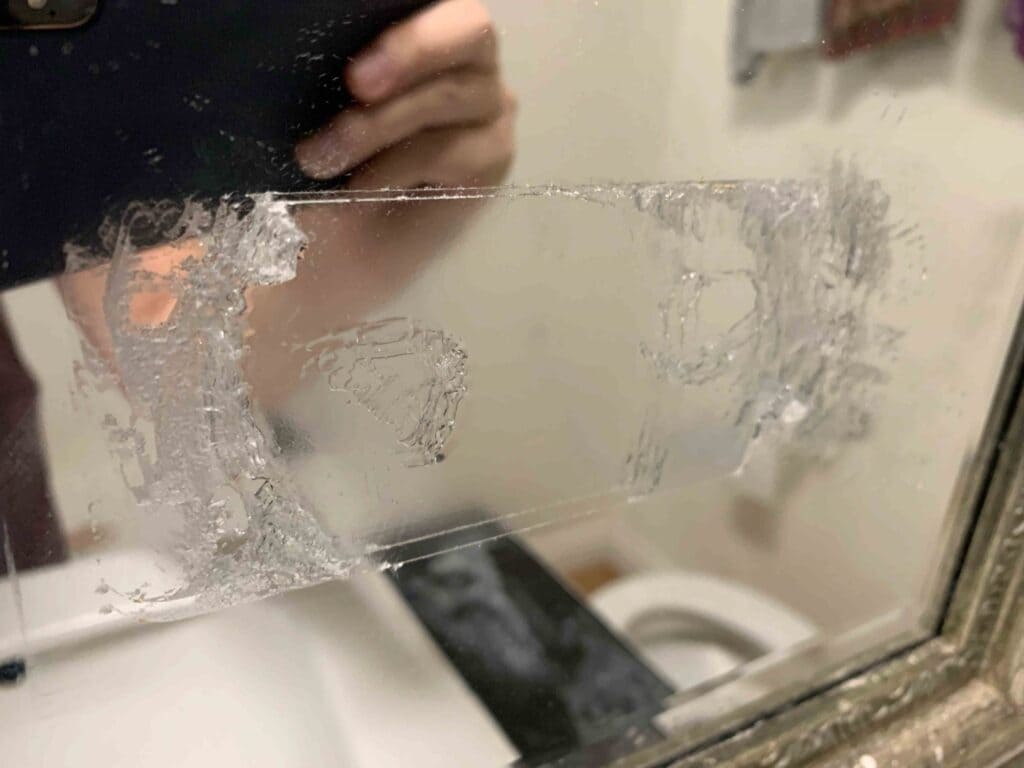 Glue sticked on a glass mirror