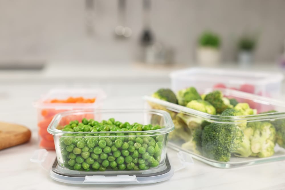 Containers With Green Peas And Fresh Products On White Table