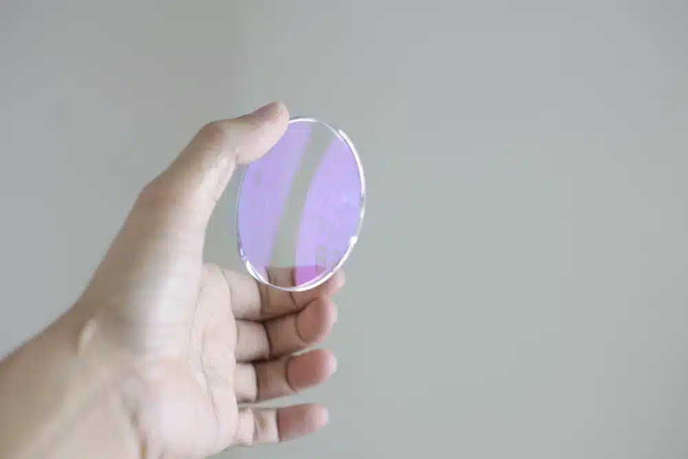 Lens glasses eyeglasses lenses in hand on grey background