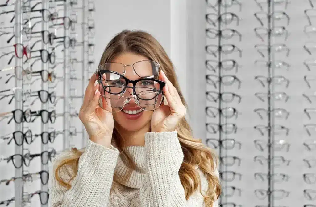 a lady trying on different glasses frames