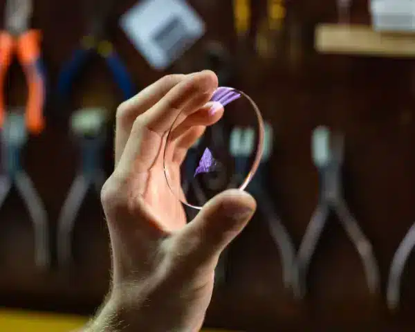 a person holding lens in his hand