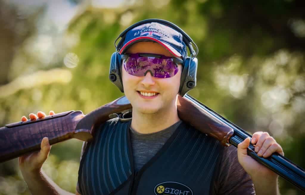 a shooter carrying a gun around his neck