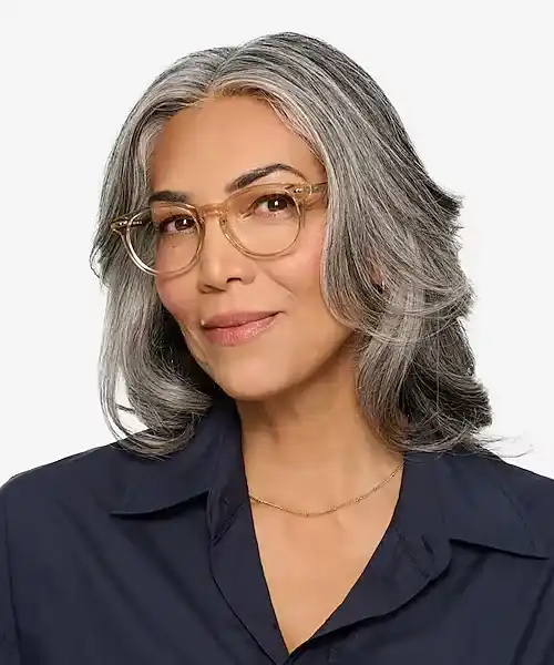 an old woman wearing roud frames on square shaped face