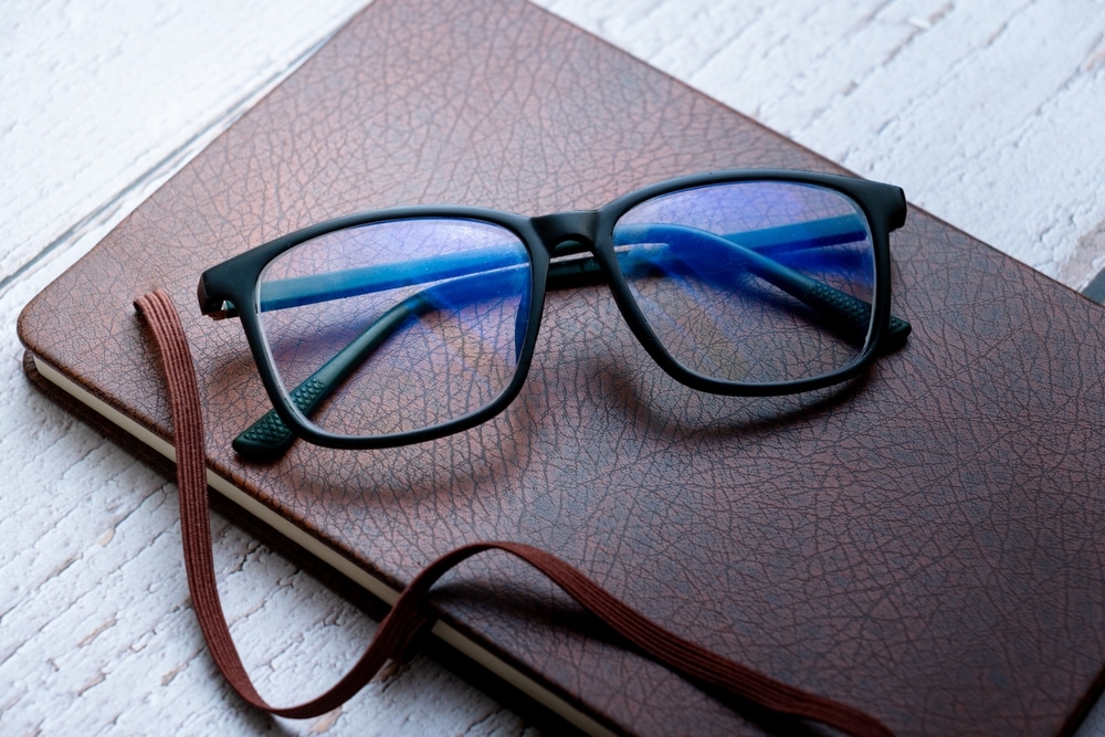 Black Frame Blue Light glasses placed on a diary 