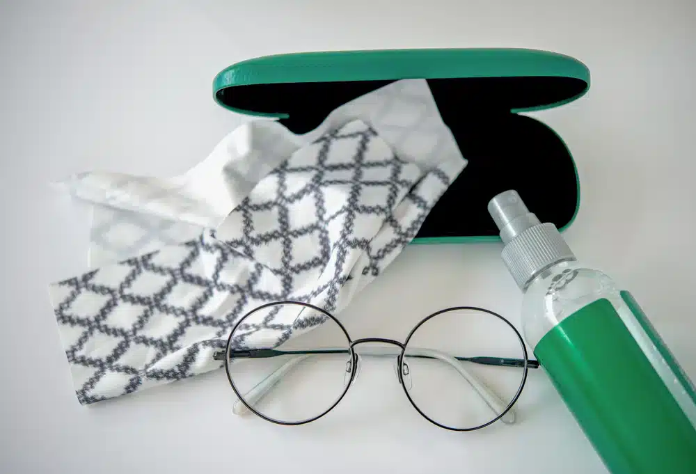 top view a set of eyes glasses cleaning accessories Eyes glasses with cleaning lens spray bottle micro fiber cloth and glassess box isolated on white