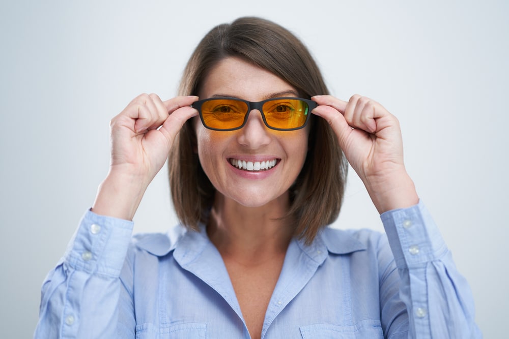 Attractive Woman Wearing Yellow Blue Blocking Glasses Isolated Over White