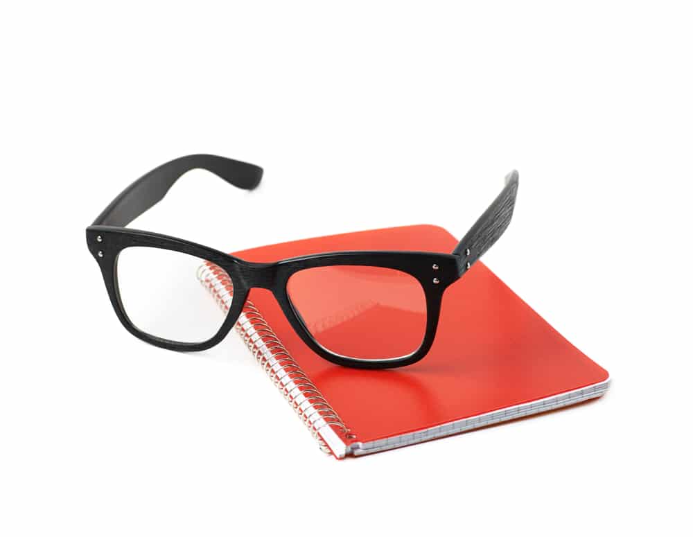 Reading Glasses Over A Squared Paper Notebook 