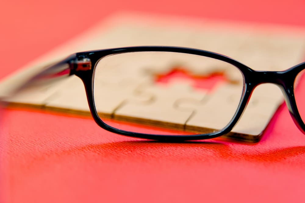 Eyeglasses Lies On A Vibrant Red Surface Surrounded By A