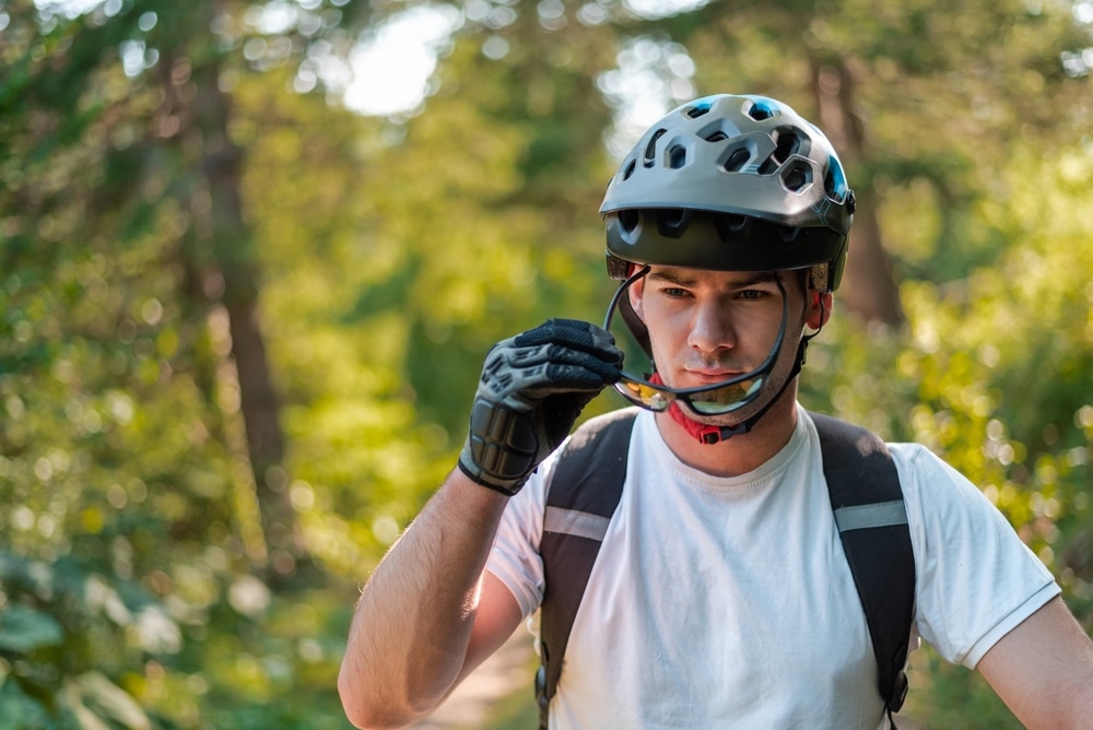 A Professional Cyclist In A Helmet Putting His glasses