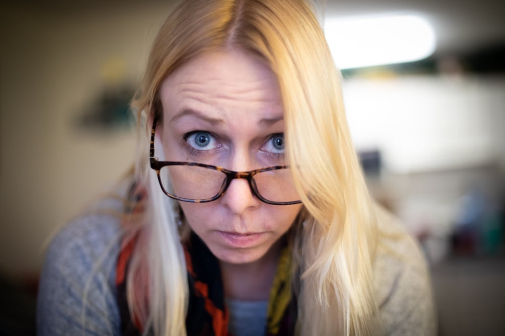 A Young Blonde Woman With Bad Eyesight And Her Glasses