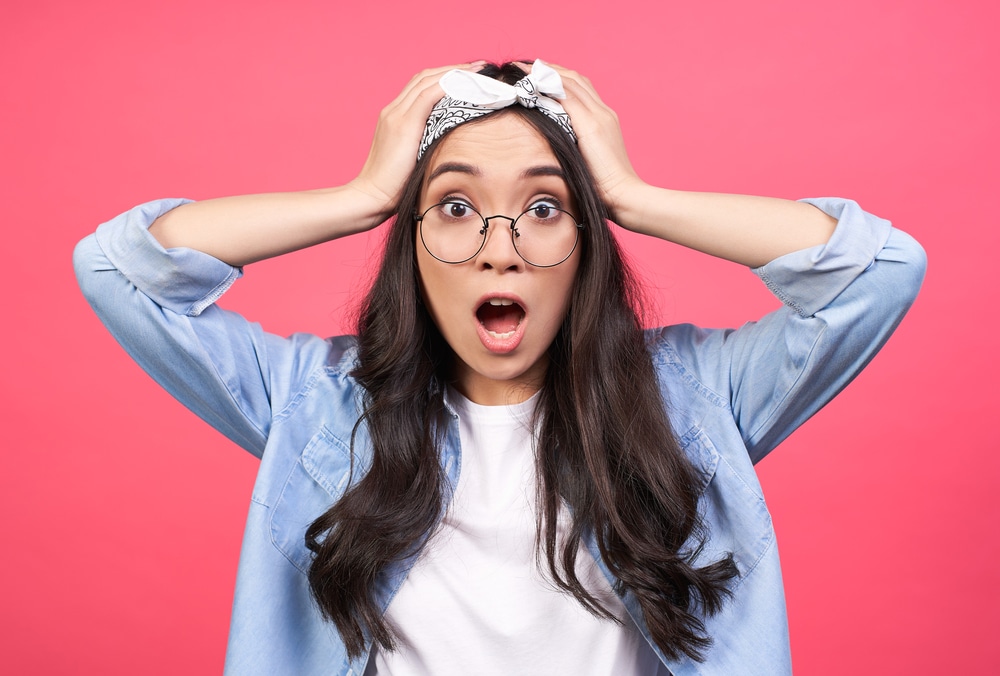 a girl wearing round glasses, wearing bandana on her head looking shocked