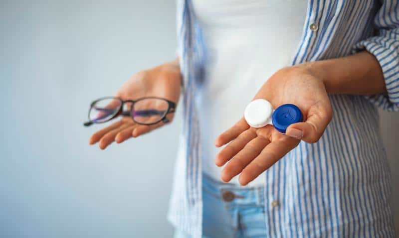 A view of hands holding lenses and glasses A view of hands holding lenses and glasses