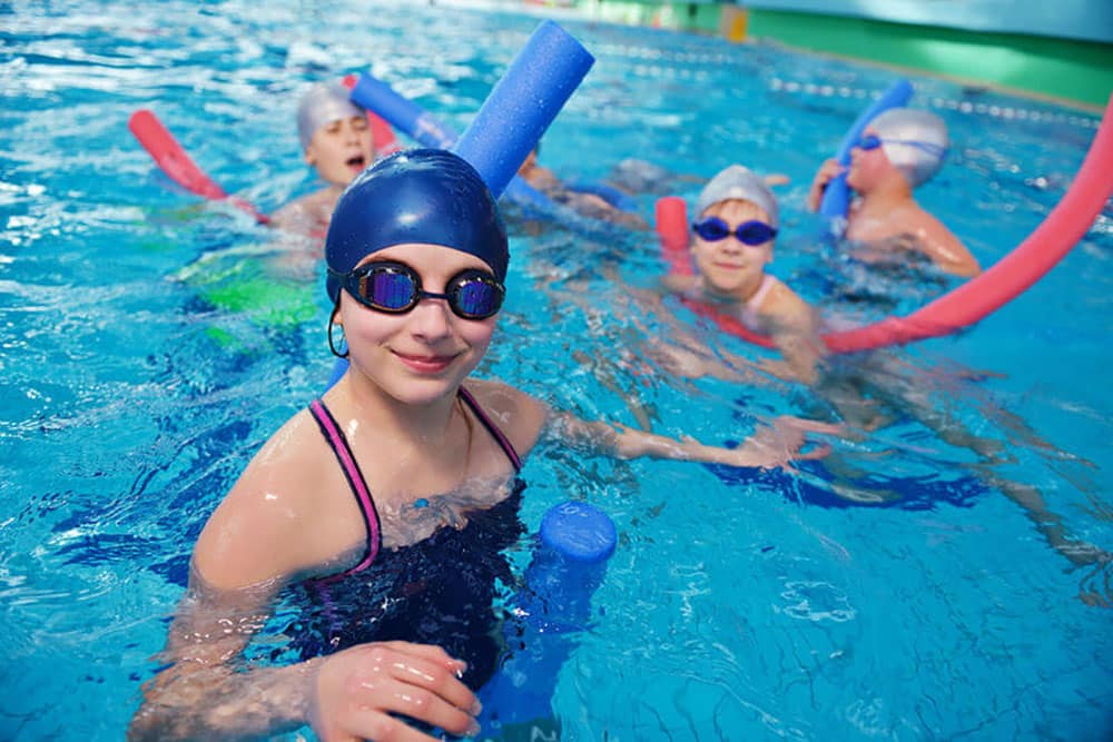 A view of an instructor teaching swimming to kids A view of an instructor teaching swimming to kids