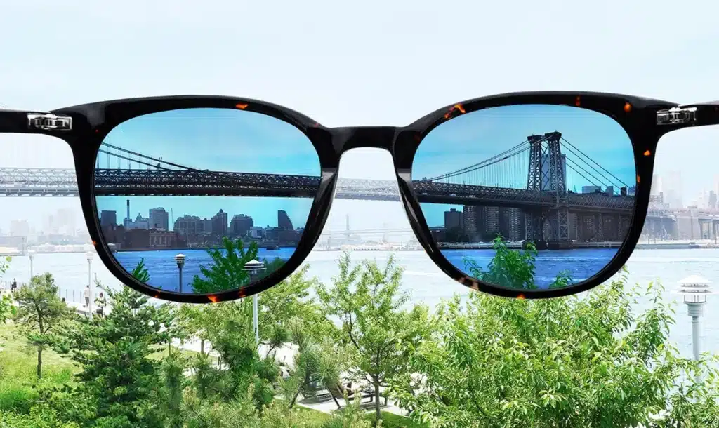 Sunglasses with polarized lenses showcasing the Brooklyn Bridge and city view Sunglasses with polarized lenses showcasing the Brooklyn Bridge and city view